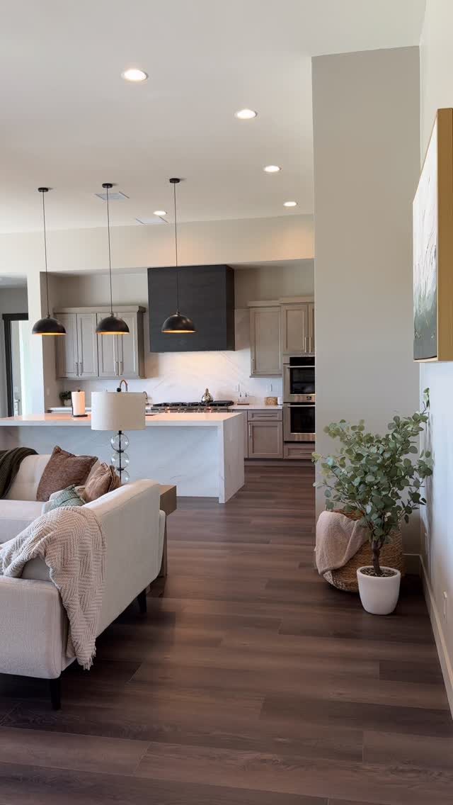 Dark Wood Floors Kitchen: 6 Looks That Balance the Floor 6 Dark wood plank flooring extending from a living room area into a modern kitchen space.