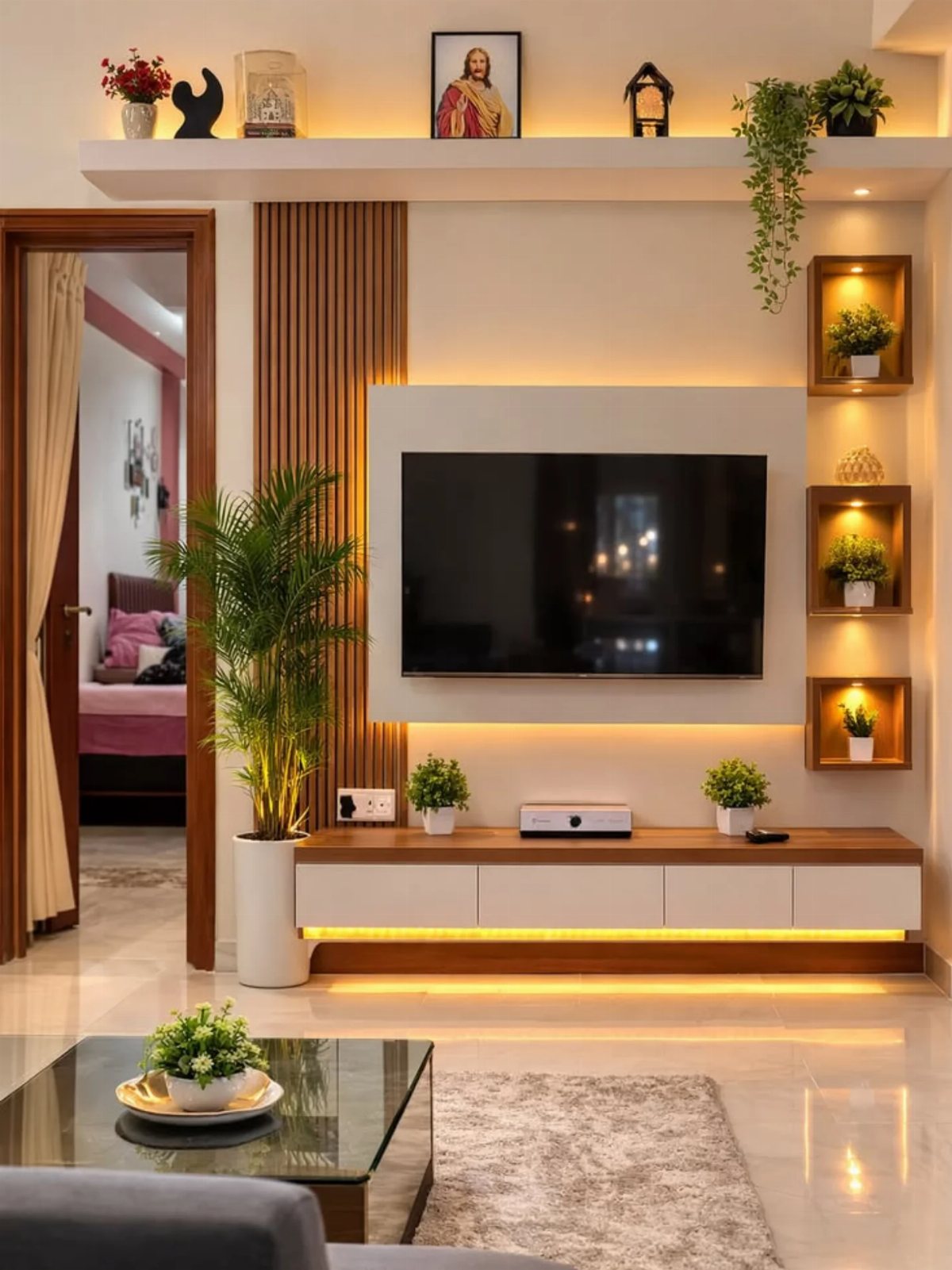 A modern living room wall featuring a backlit TV, wooden accents, and small decorative plant niches.