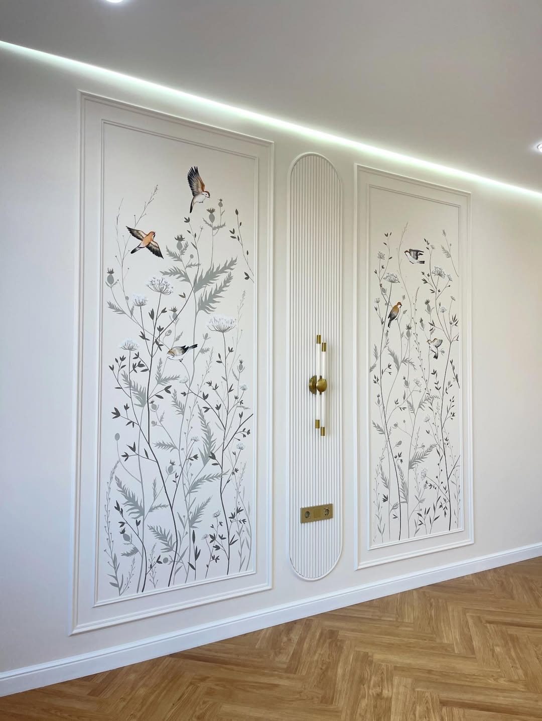 Molding Boxes on Wall: 6 Styles From Grid Panels to Botanical Frames 6 Two large rectangular wall moldings with botanical bird illustrations on a white wall above wood floors.