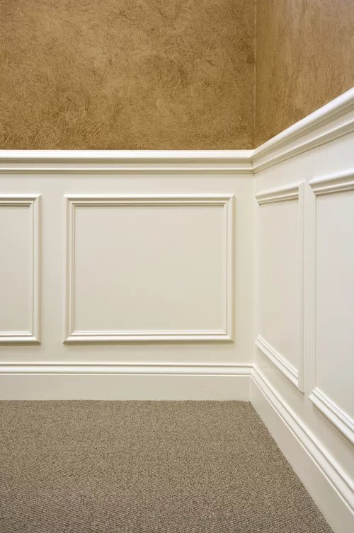 Molding Boxes on Wall: 6 Styles From Grid Panels to Botanical Frames 4 White rectangular wall molding panels installed on a lower wall section with tan textured upper walls.