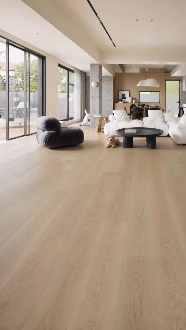 Natural oak wood flooring in a bright, modern living room with white furniture.
