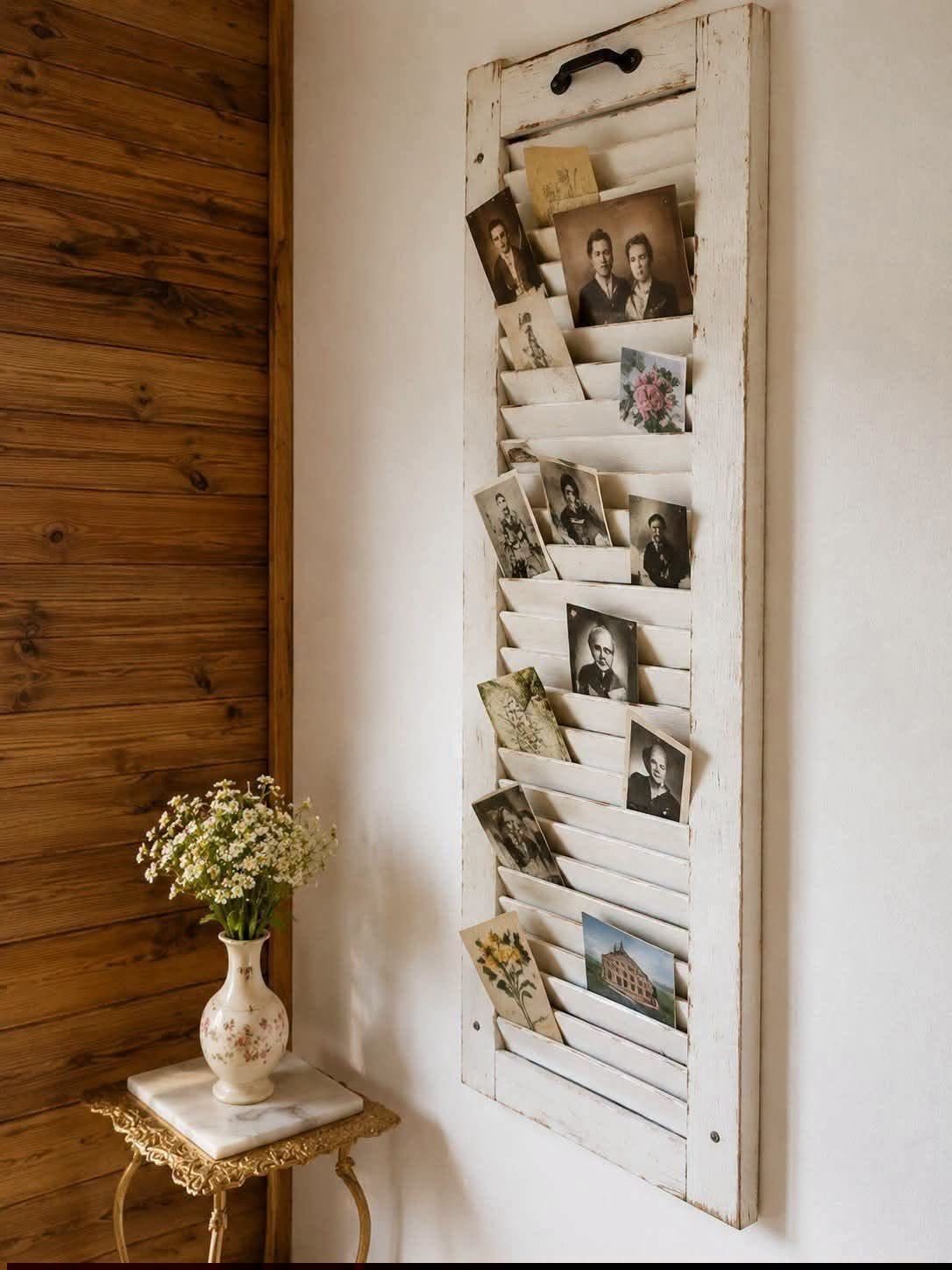 21 Bedroom Wall Decor Ideas With Photos for Every Style 5 Vintage white wooden shutters mounted on a wall displaying several old photographs.