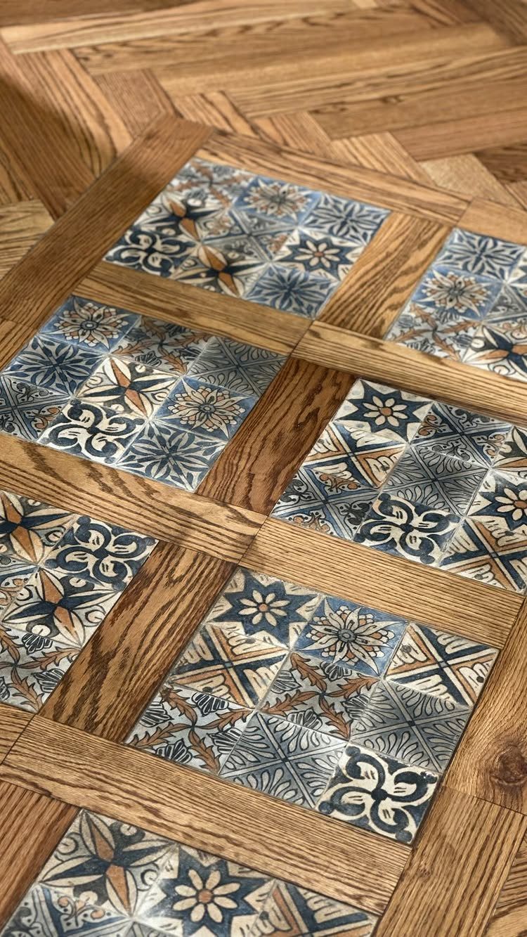 Kitchen Floor Tiles Design: 13 Ideas for Stone, Ceramic & Patterned Floors 13 Patterned blue and white tiles embedded within a light brown wooden herringbone parquet floor.