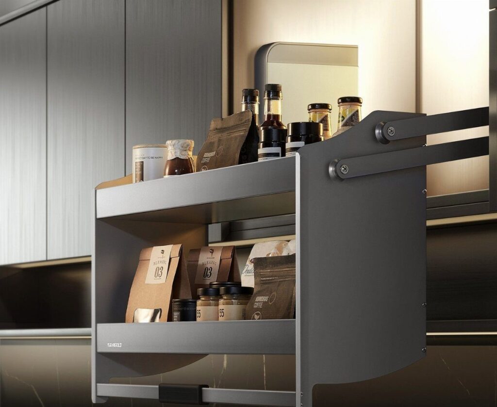 A grey tiered pull-down kitchen rack holding various jars and coffee bags inside a cabinet.