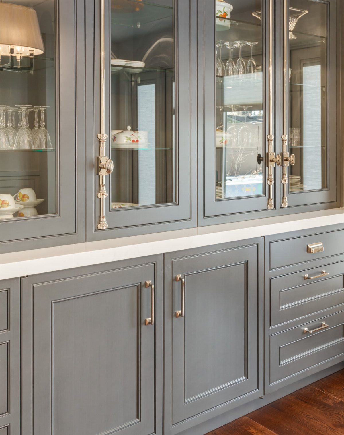 15 Kitchen Renovation Ideas for Getting the Function Back Into the Room 8 Grey kitchen cabinets featuring various metallic handles and pulls on glass and solid doors.