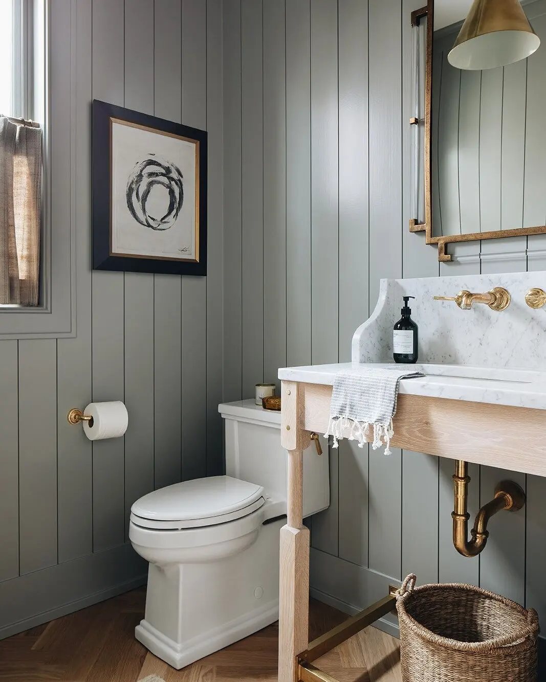 Grey vertical shiplap paneling on the walls of a modern bathroom with a white toilet.